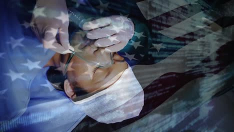 animation of flag of usa waving over surgeons in operating theatre