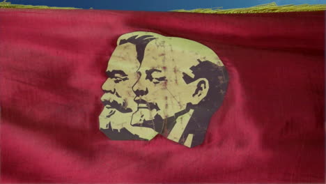 slow motion close up of a portrait of marx and lenin on a soviet flag