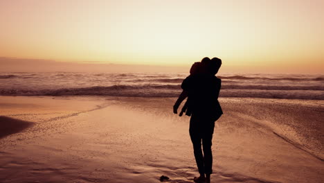 Sunset,-beach-and-dad-spinning-child