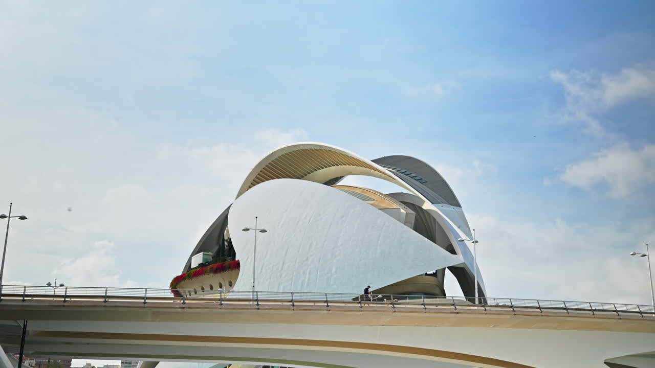Valencia, Spain - May 20, 2025: Futuristic curves of the Palau de les Arts Reina Sofia rise above a bridge in Valencia's City of Arts and Sciences on a bright day