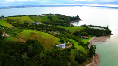 aerial view of a lush green coastal peninsula with houses
