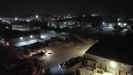 snow plow clearing sidewalks and roads during a winter storm in the town of orford, québec, canada