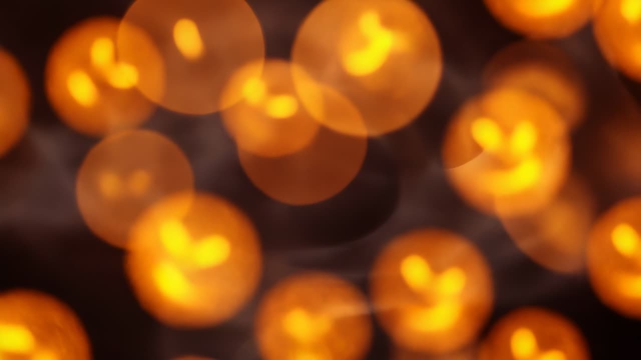 Pumpkin orbs starting with glow, then drifting and pulsing in dark void, creating hypnotic dance
