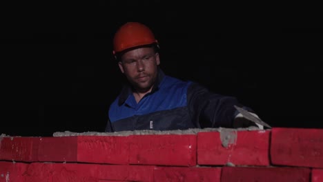 bricklayer working at night