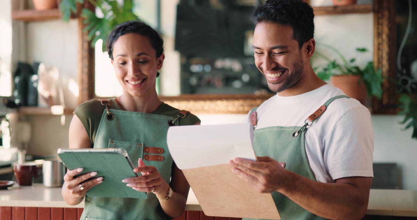 Two Coffee Shop Employees Reviewing Inventory and Orders