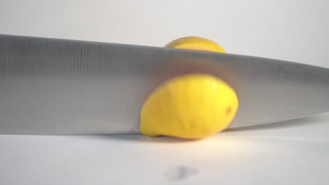 close up slow motion yellow guava fruit chopped with knife, white background