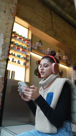 woman using phone in a cafe