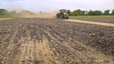 Farming-tractor-working-on-arable-field.-Agricultural-tractor-plowing-land