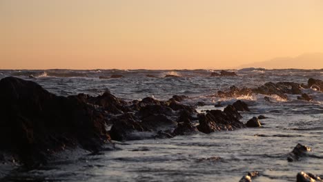 wild sea with crashing waves during beautiful sunset at ocean