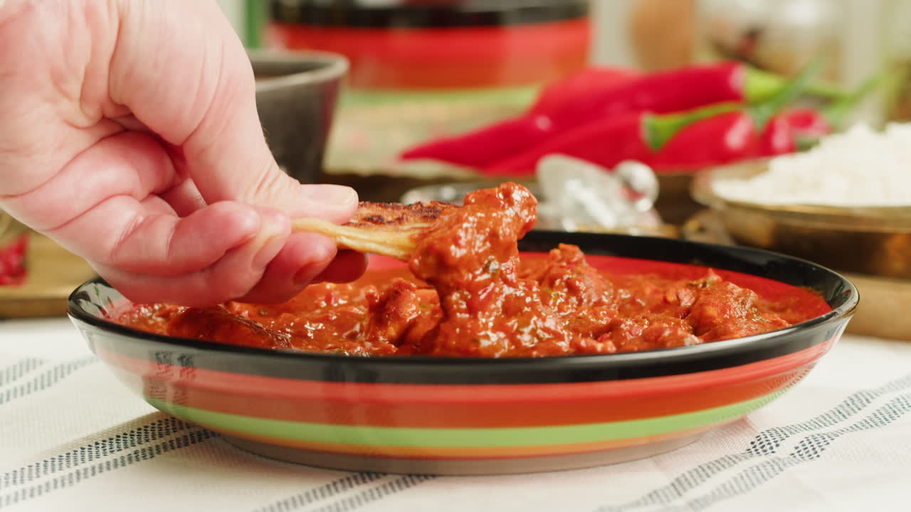 Assorted indian sri-lanka food set on wooden background. Dishes and appetisers of indeed cuisine, rice, lentils, paneer, samosa, spices, masala. Bowls and plates with indian food top view chicken. High quality 4k footage