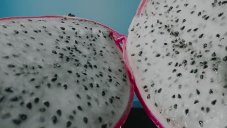 Two-slices-of-dragon-fruit-with-blue-background