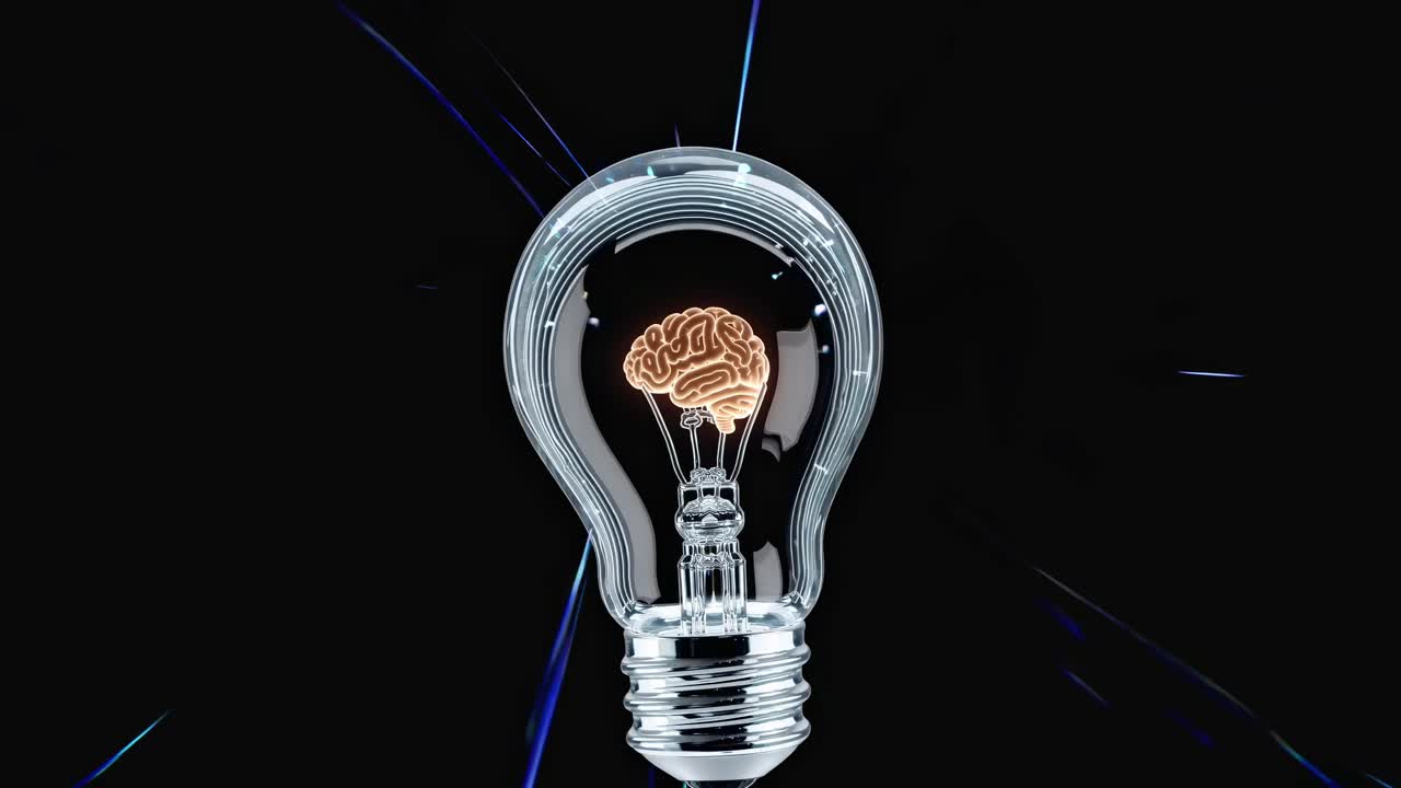 Close-up video of a light bulb with a brain inside, set against a dark background