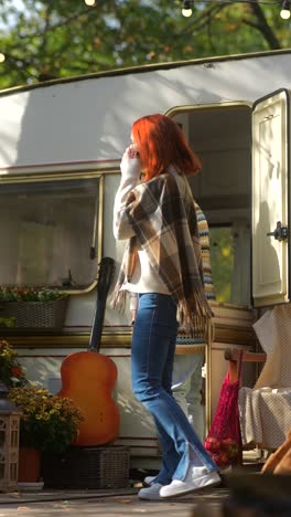 friends enjoying autumn day by camper trailer