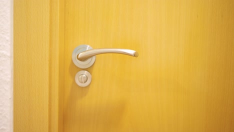 man opening and closing bathroom door