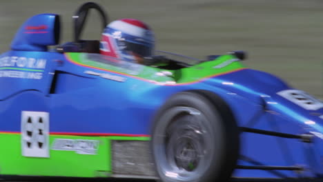 a race car driver accelerates out of a sharp turn