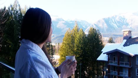 Woman-having-a-cup-of-coffee-in-balcony