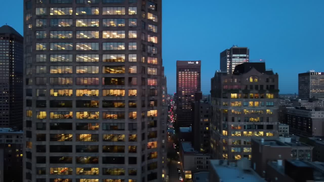 Stunning Evening Skyline: A Glimpse of Urban Life Illuminated by City Lights and Reflective Glass Structures Against a Twilight Sky