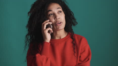 African-american-woman-using-smartphone-over-blue-background.