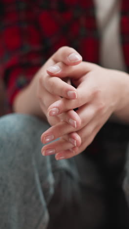 woman rubs palms sitting on steps closeup. girlfriend prepares to breakup with abusive boyfriend on staircase. nervous lady deals with panic attack