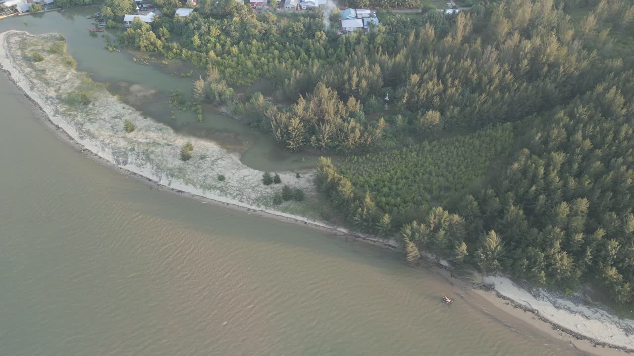 Aerial Drone View During Summer Gerigat Fishing Village,Kabong With, Facing Open Blue Sea, White Sandy Beach,Green Coconut, Palm Trees,And River,Sarawak,Borneo