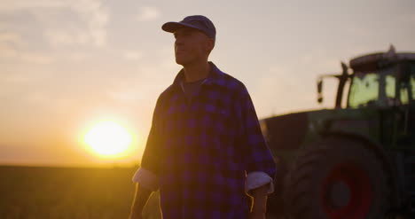 farmer using digital tablet at farm against sunset 2