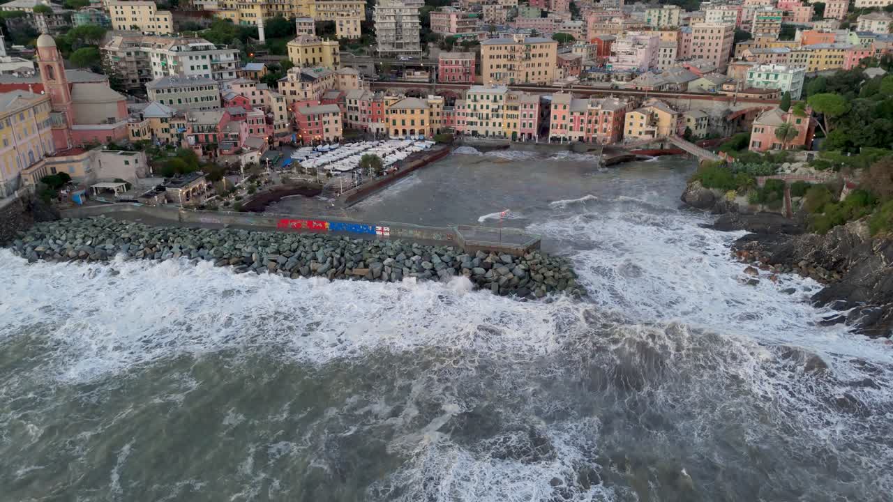 Big foamy sea waves crashing on pier wave braker in Genoa city harbor