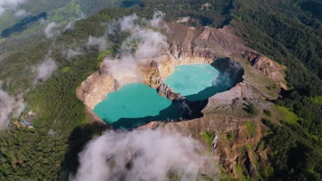 An-Aerial-Shot-Of-Blue-Volcanic-Crater-Lakes-On-A-Hilltop-With-A-Large-Forest