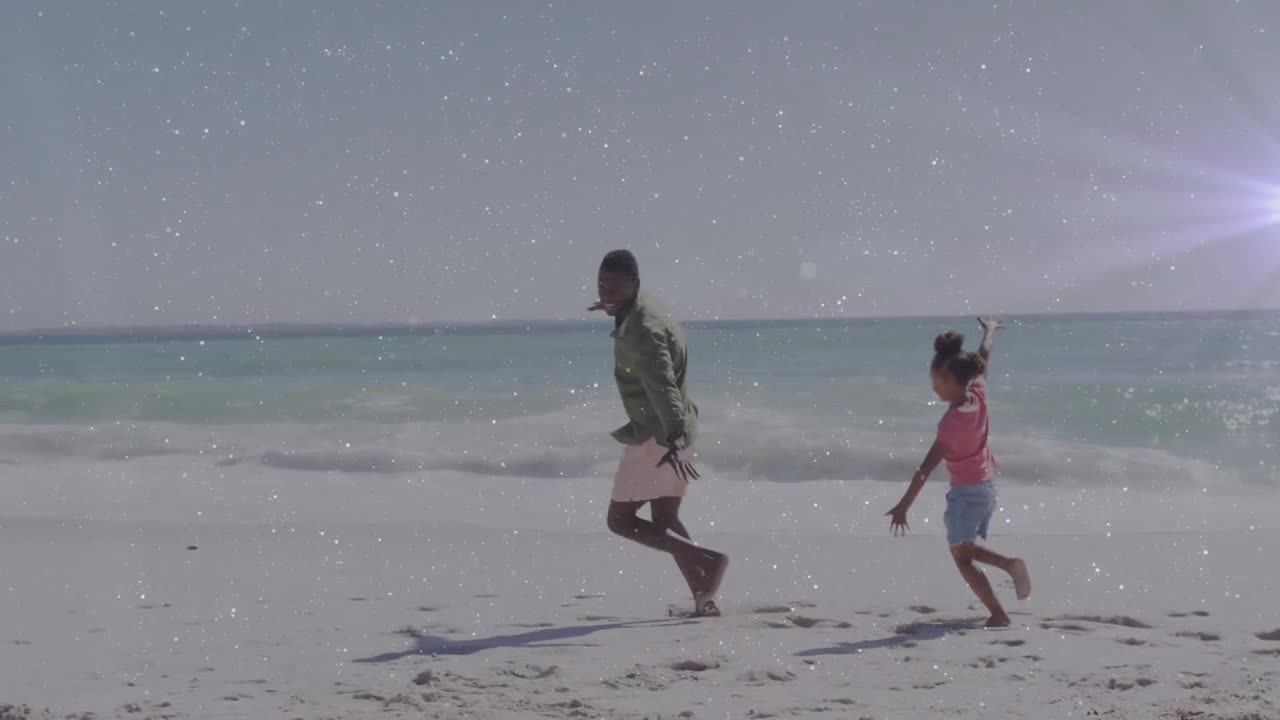 해변에서 아프리카계 미국인 남성과 그의 딸 위에 빛의 흔적의 애니메이션