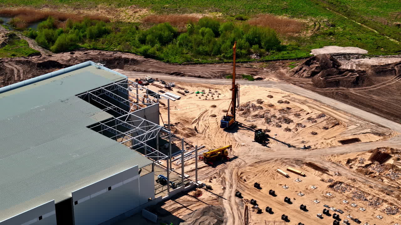 Warehouse under construction building site industrial hall factory, aerial drone view