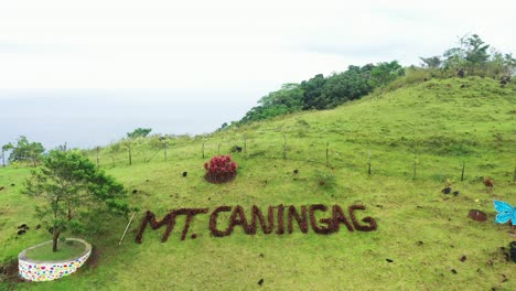 landscape in mountains, grassy field of hills - rural scenery at caningag mountain park in pintuyan, southern leyte, philippines - aerial drone shot