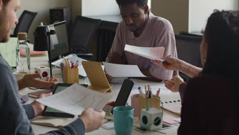 professionals collaborating and discussing data in an office meeting