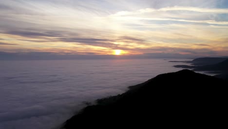 aerial view of beautiful sunset over sea of clouds
