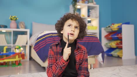 a smart kid is studying in his room.