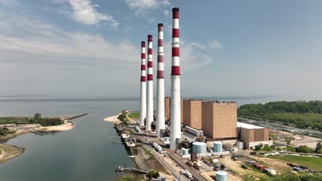 an aerial view of a large power plant on a sunny day with blue skies and white clouds