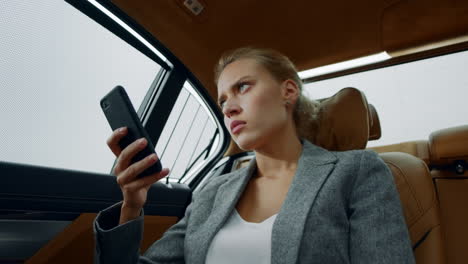 Closeup business woman getting bad news on phone. Sad girl sitting in vehicle