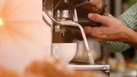 Animation-of-glowing-orange-light-over-caucasian-male-barista-making-coffee