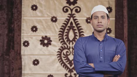 confident muslim man standing crossed hands with copyspace