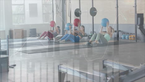 animation of data on interface over diverse women holding medicine balls cross training at gym