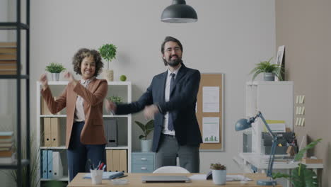 happy business colleagues dancing in office