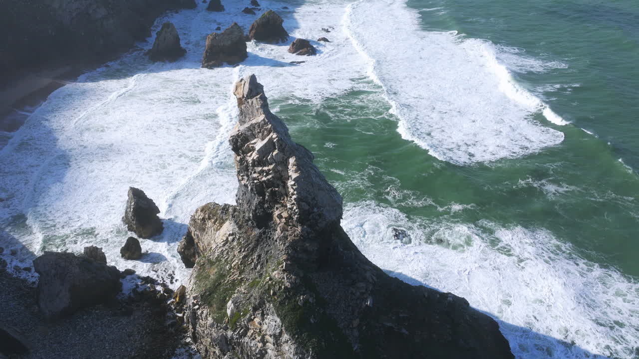 Early morning aerial drone shot of Portugal’s Praia da Ursa, highlighting the coastline near Cabo da Roca.