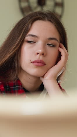 disheartened woman sits in kitchen room. sad lady grapples with stress of uncertain future particularly pressing challenges of financial problems