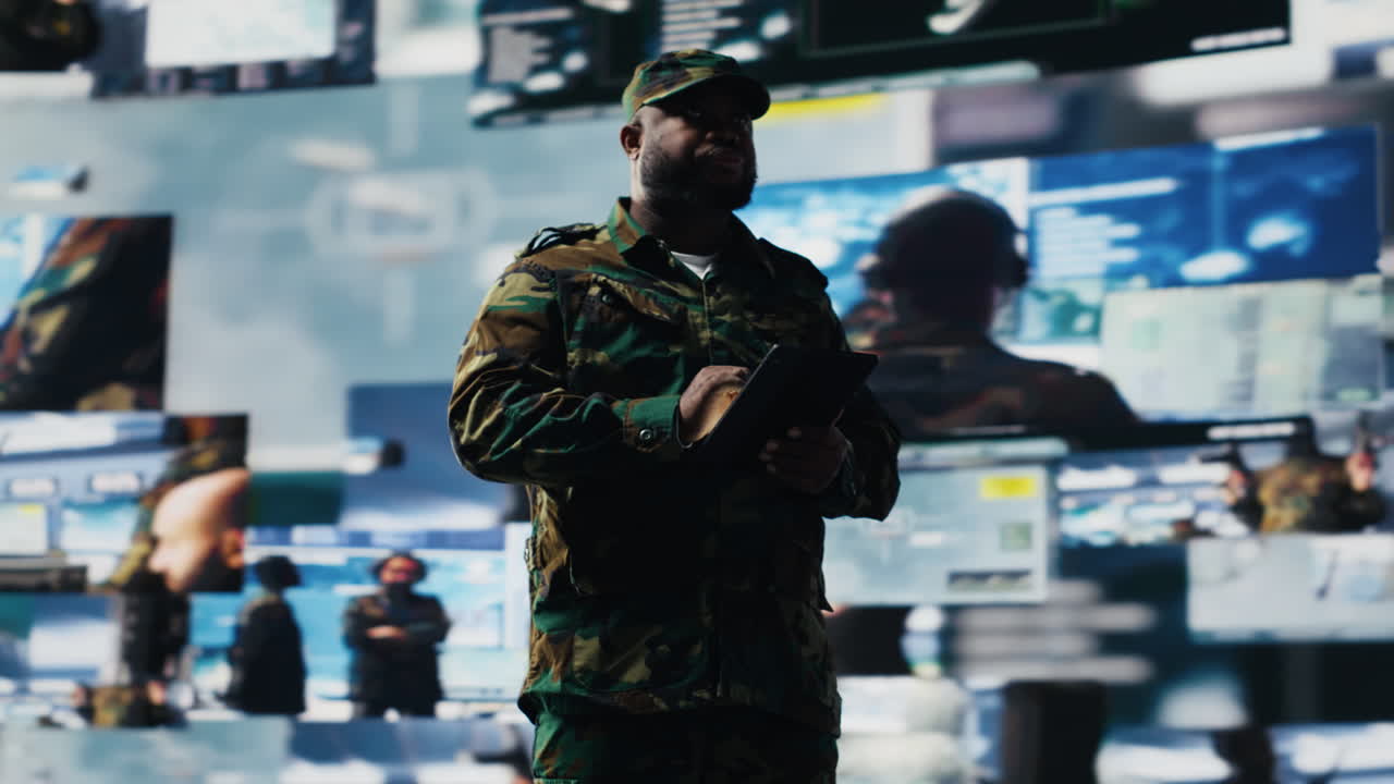 African american soldier works in command center with satellite data