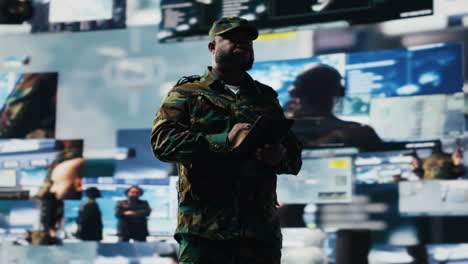 african american soldier works in command center with satellite data