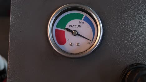 camera zooms out revealing a vacuum gauge, auto shop, bangkok, thailand