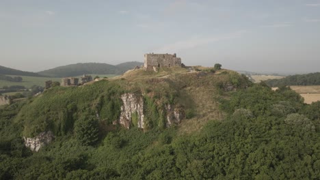 dramatic rocky outcrop of dunamase castle against agricultural landscape at county laois in dunamaise, ireland