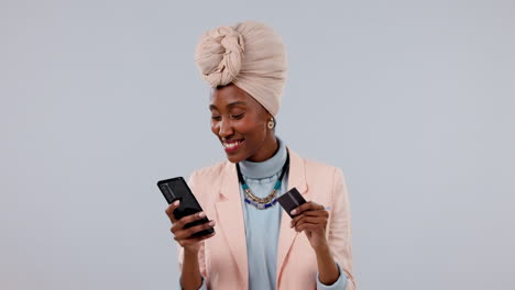 Credit-card,-phone-and-happy-woman-in-online