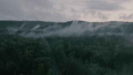 drone hovering looking at beautiful foggy mountain top landscape-2