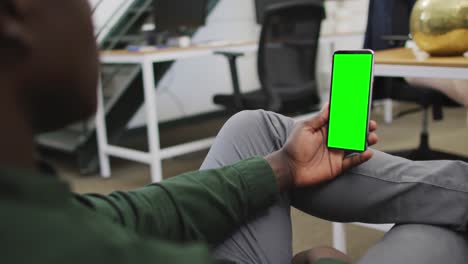 African-american-businessman-using-smartphone-for-video-call-with-copy-space