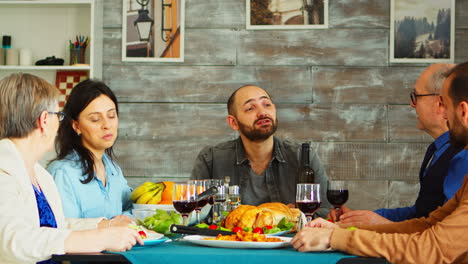 young bearded man making a toast with red wine