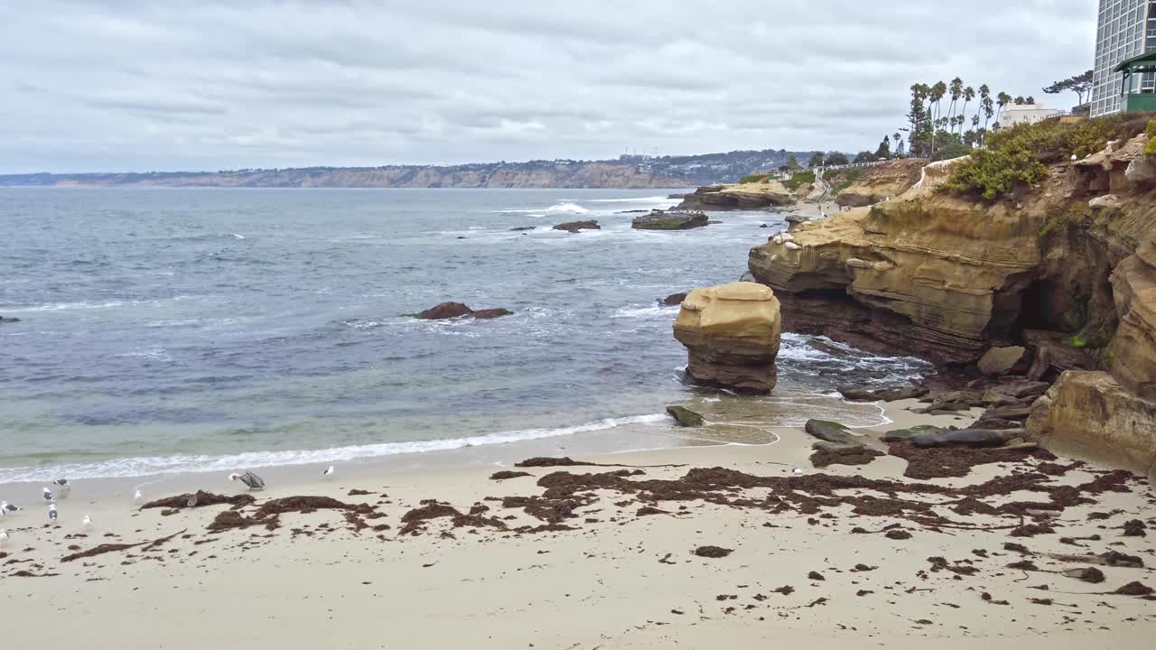 Blue ocean waves flowing to the shore of La Jolla affluent in San Diego